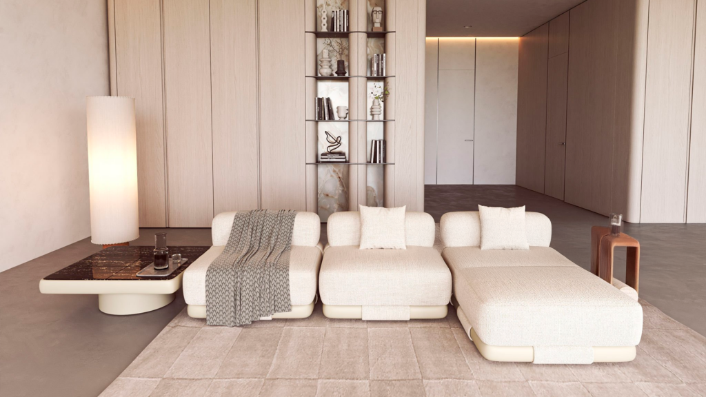 Sofá modular de três lugares em tecido off-white com design curvo, almofadas decorativas e manta cinza em uma sala de estar minimalista.